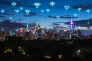 Is public Wi-Fi safe of which this image is of a city skyline and virtual data images above the buildings simulating wifi networks.